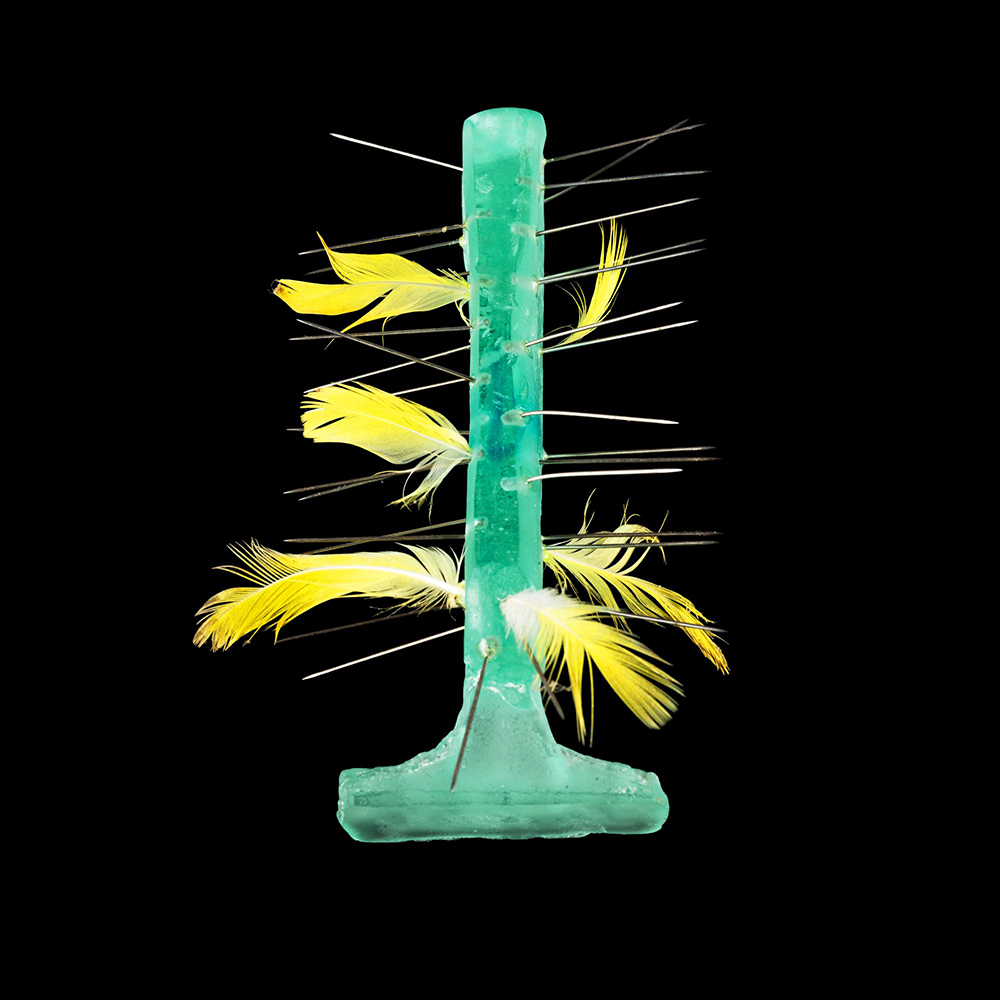 Hannah Bremner, Feathered Razor, The Imaginary Archives Series, 2022, lost wax casting/mixed media, lead crystal, steel pins, budgie feathers