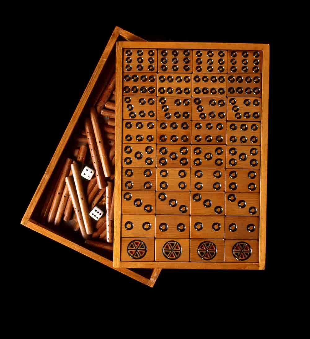 How do you fill the long evenings during lock down? In 1943 when this Mahjong set was made, there was no Netflix for entertainment. At the Prisoner of War Camp in Featehrston during WWII, many of the Japanese prisoners held there spent leisure time making objects they could trade with the guards for cigarettes and other items. They made carvings with traditional motifs – chrysanthemums, frogs, snakes, landscapes – and paintings filled with nostalgia for home. The mah-jong sets were for their own use too – a popular pastime to fill in the evening hours. This set, beautifully made with great attention to detail, was acquired by the Ennor family from a former camp guard. The plastic used for the hinges is from toothbrushes.