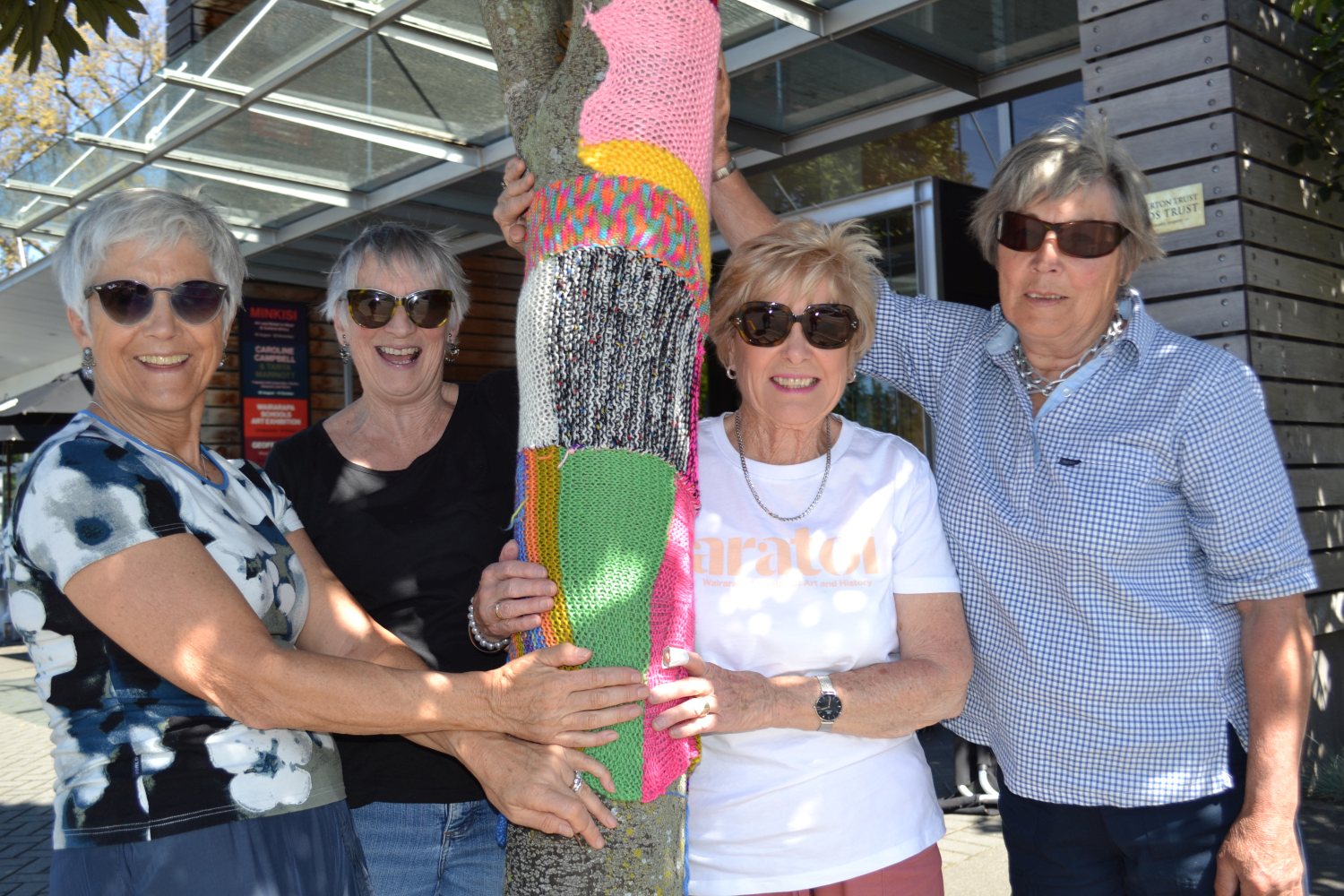 BLOCK PARTY 2018 Volunteers: Donna Burkhart, Sandra Debney, Barb Roydhouse and Megan Payton with the tree they knit-bombed.