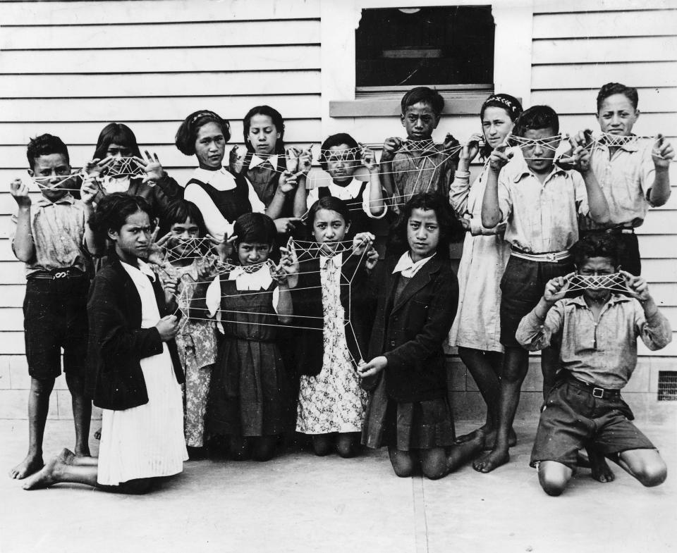 A group of children holding string patterns